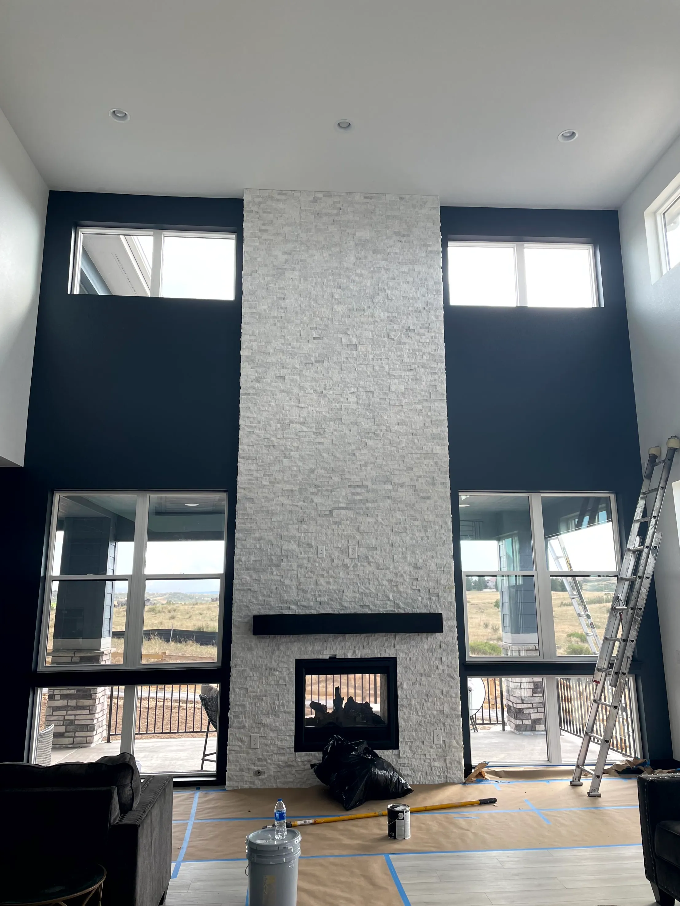 Two-storey fireplace wall painted navy