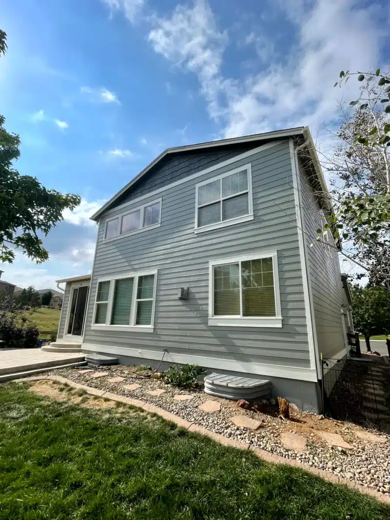 Sage green two-story home exterior repaint