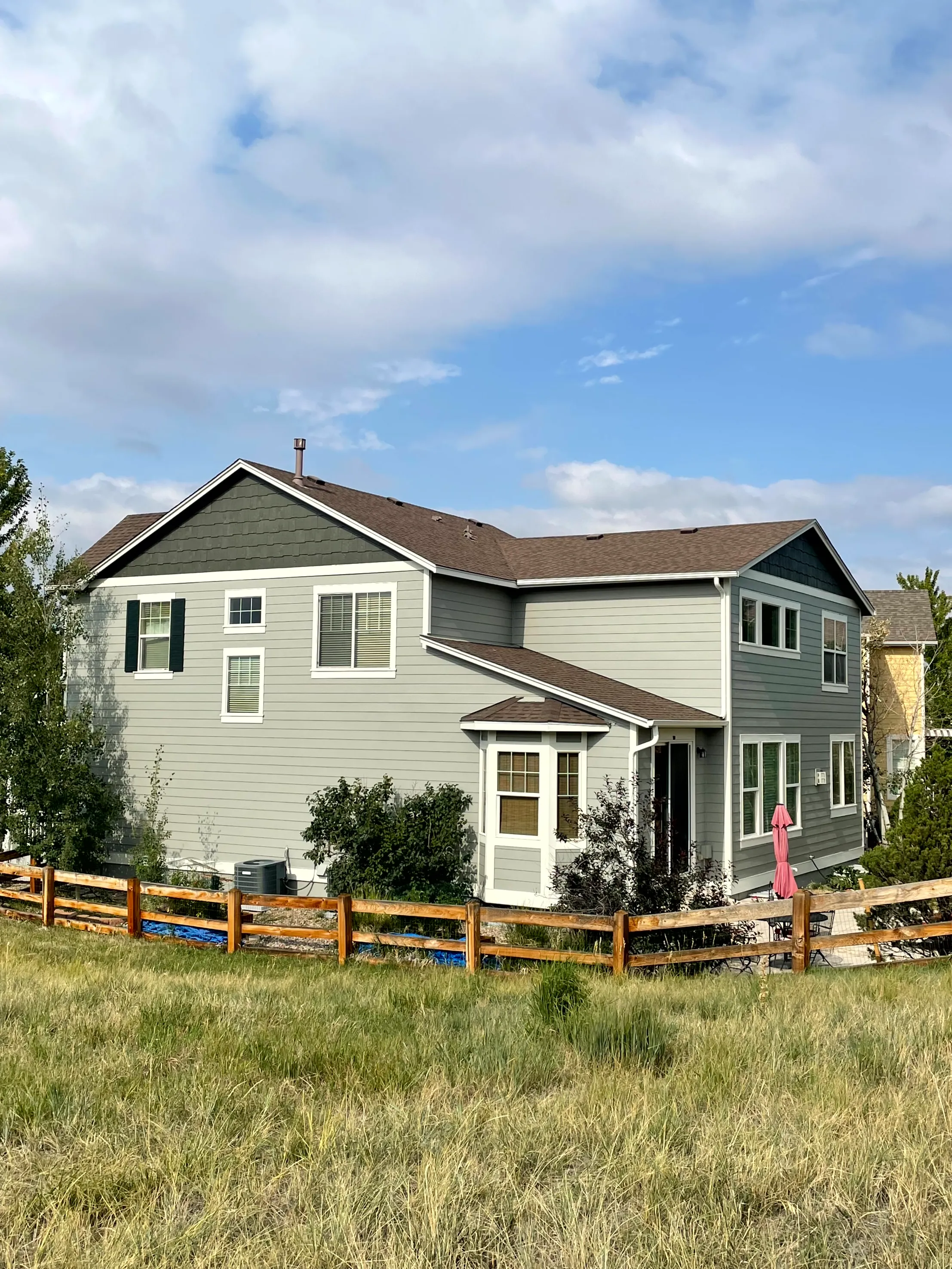 Exterior painting — green and tan siding with white trim