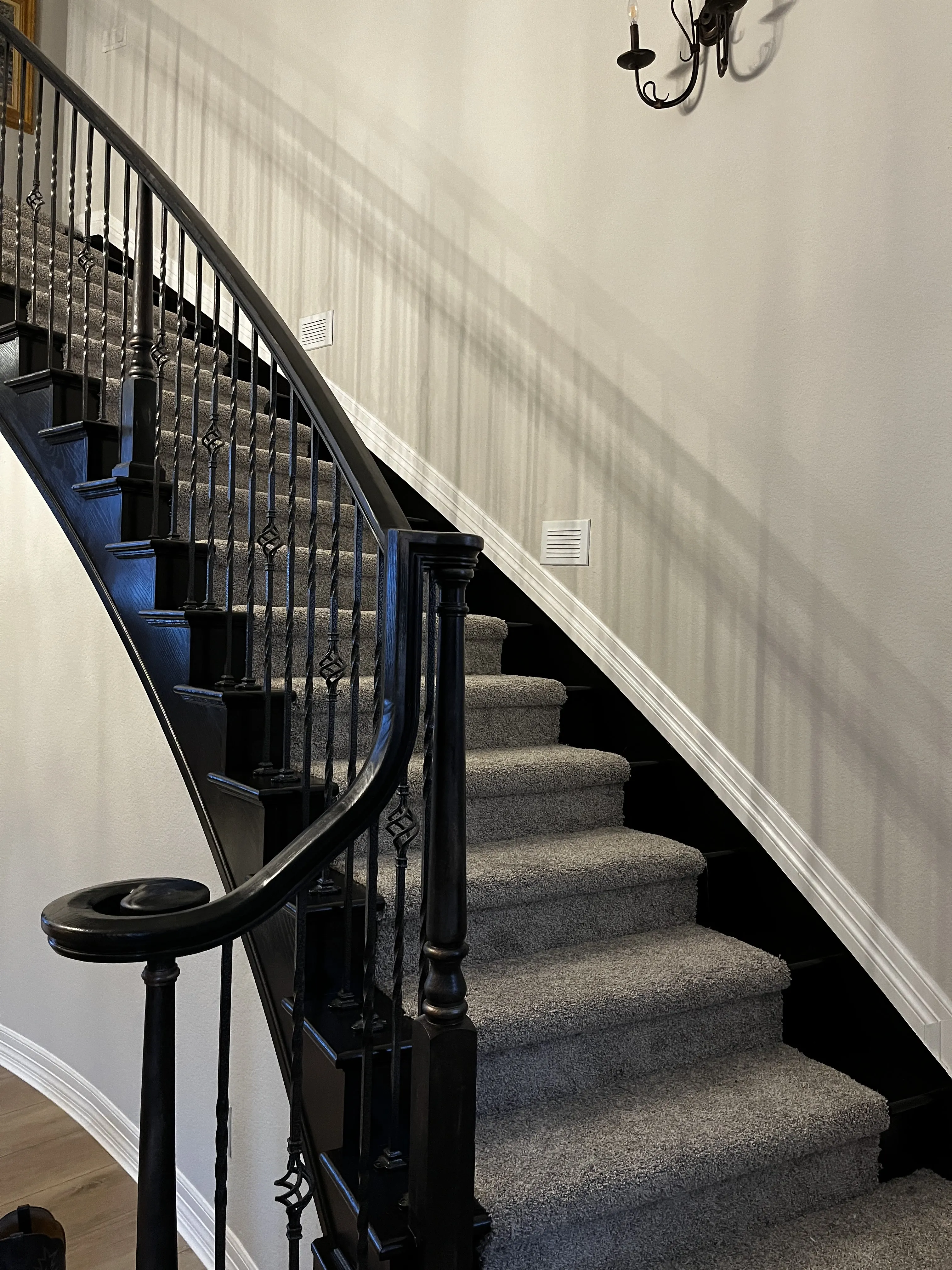 Interior painting — staircase with painted risers and handrail