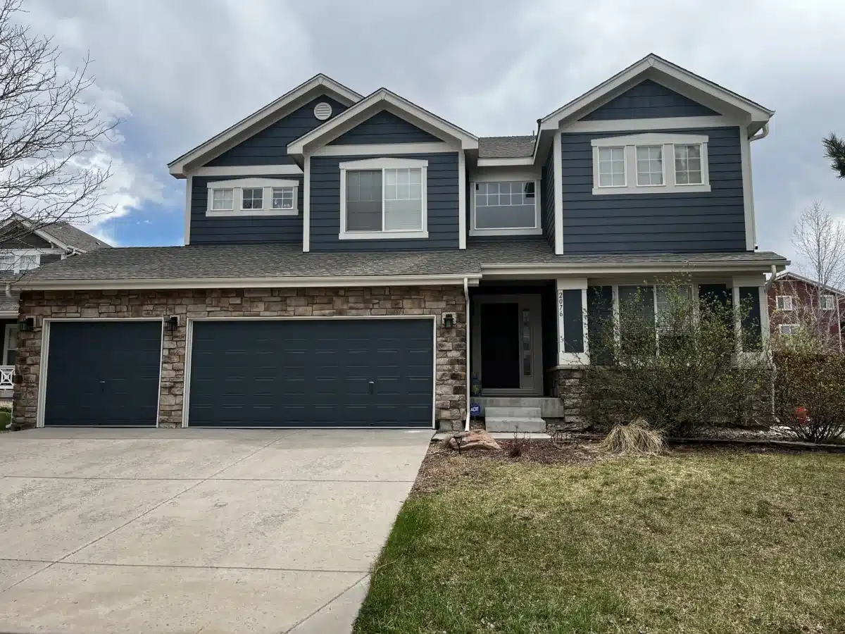 Two-story dark blue home exterior repaint in Colorado