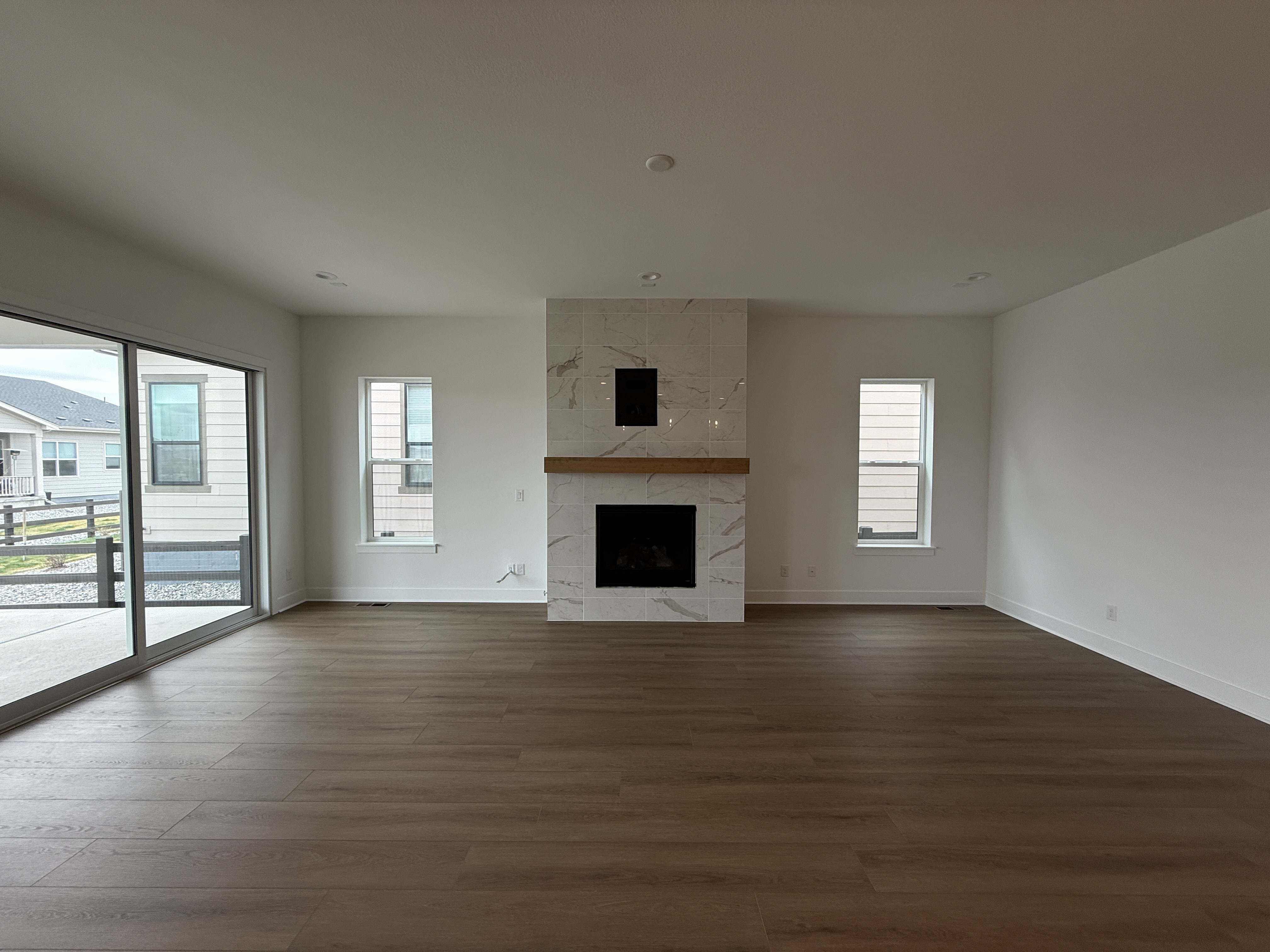 Interior living room with smooth repaired walls and a freshly painted fireplace surround